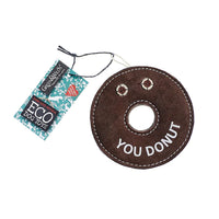 A brown, donut-shaped dog toy made from eco-friendly materials. The toy has the words 'YOU DONUT' embroidered on it, with a tag that says 'GREEN&WILD's ECO DOG TOYS'.